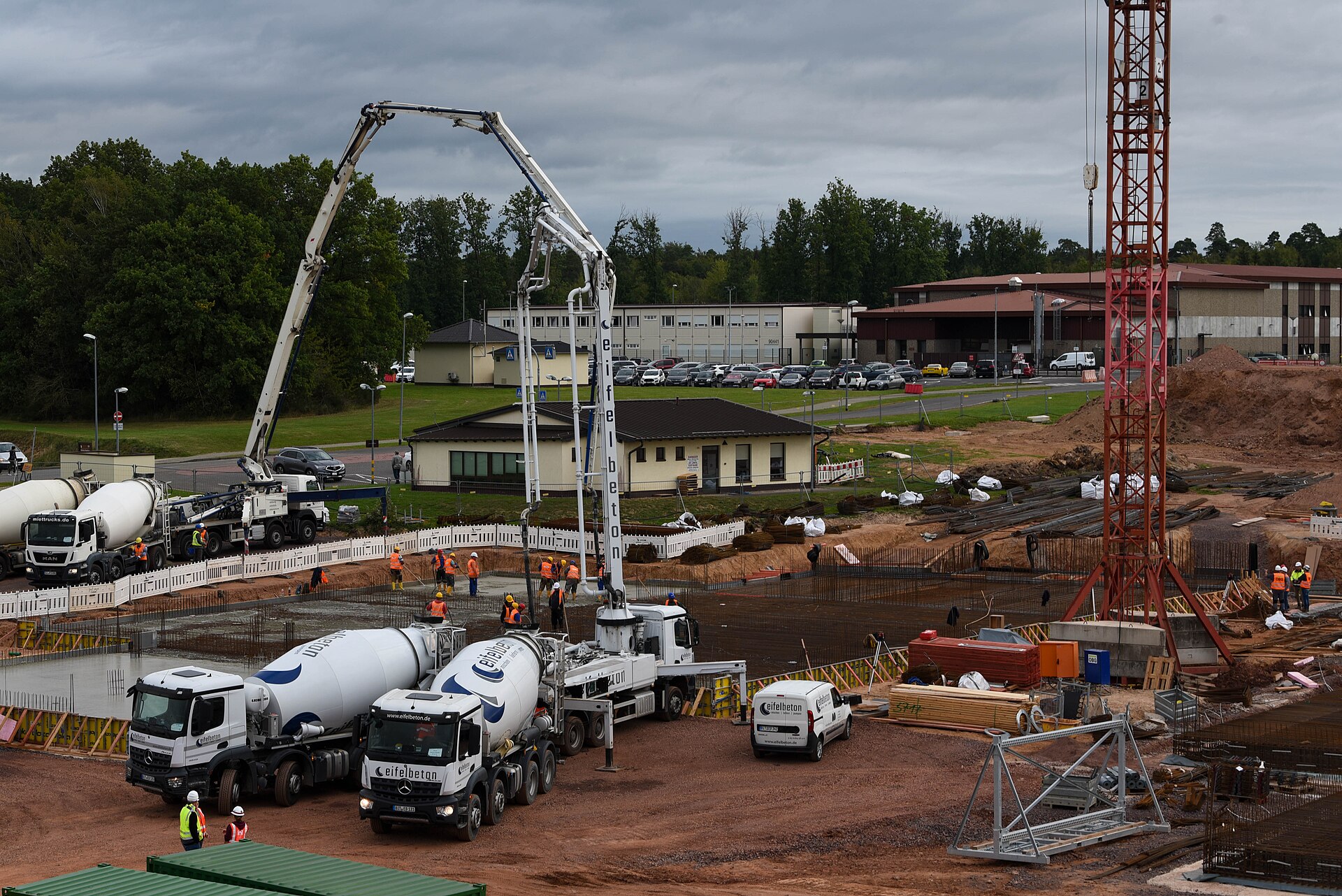 Ready mix trucks and pump pouring concrete at a construction site