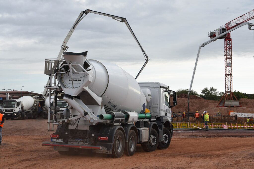 Concrete mixer truck with pump boom pouring ready mix