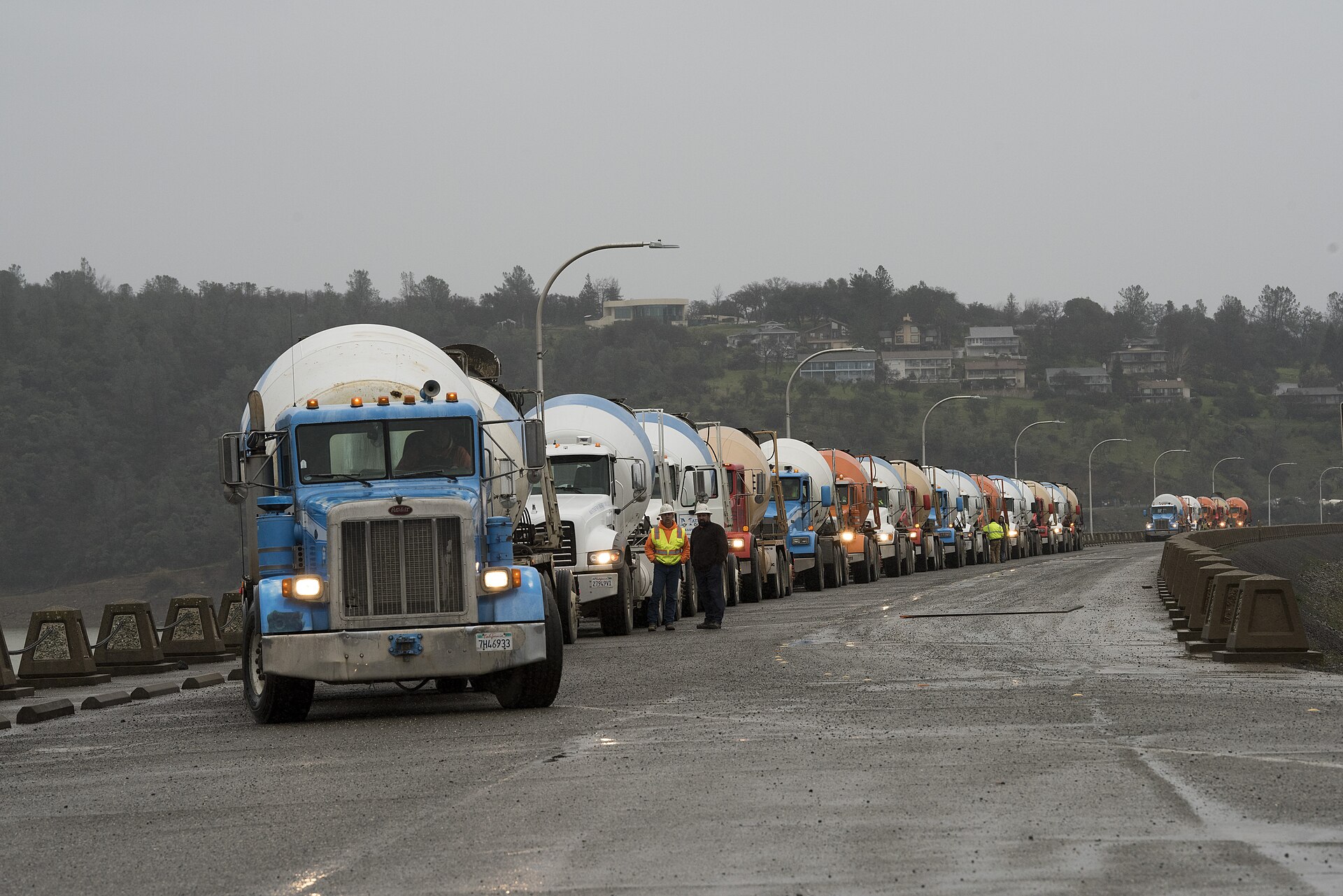 Line of ready mix concrete mixer trucks on a job site